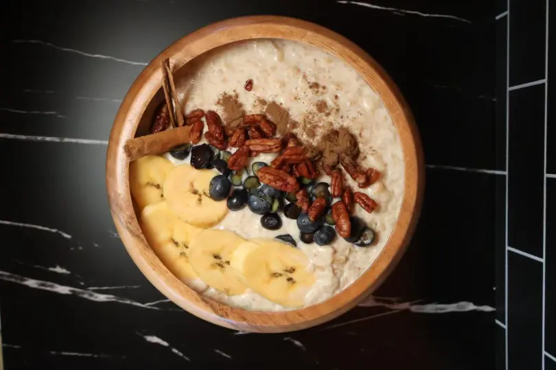 Oatmeal with banana, blueberries, and pecans.