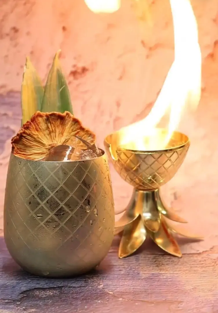 Pineapple-shaped cocktail glass with a flame.