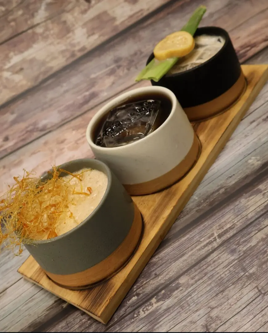 Three desserts on a wooden tray.